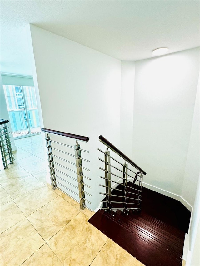 stairway featuring tile patterned flooring