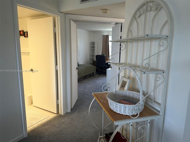 corridor featuring visible vents and carpet flooring
