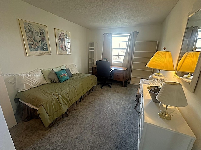 carpeted bedroom featuring a textured ceiling