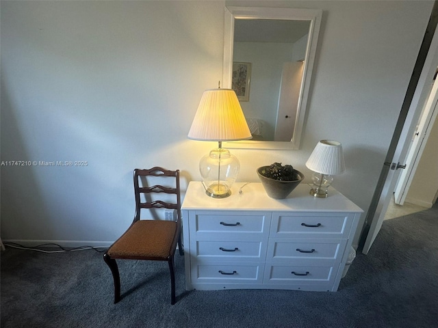 living area featuring baseboards and carpet flooring