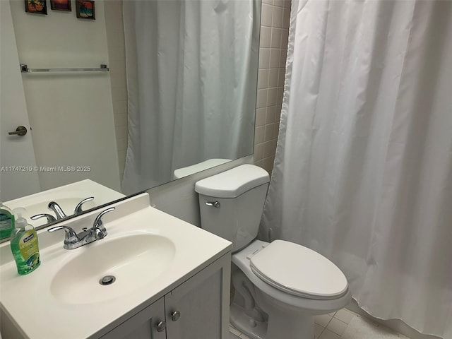 bathroom with tile patterned flooring, vanity, curtained shower, and toilet