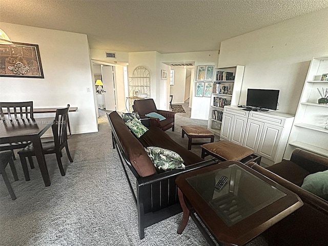 carpeted living room featuring a textured ceiling and visible vents