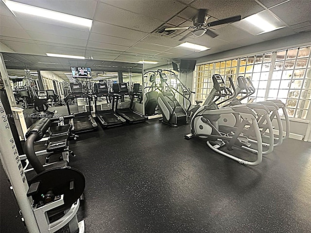 gym with a drop ceiling and a ceiling fan