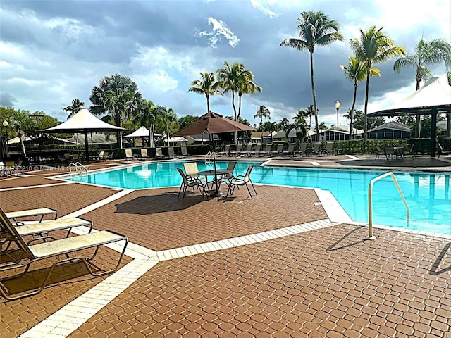 pool with a gazebo and a patio area