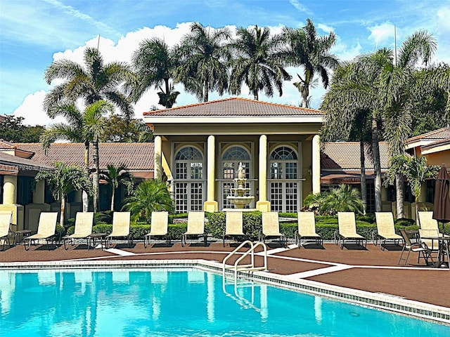 pool featuring an outbuilding and french doors
