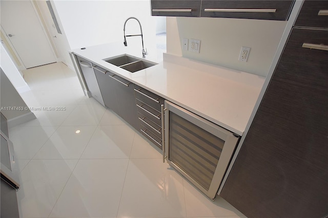 kitchen featuring sink, beverage cooler, and light tile patterned floors