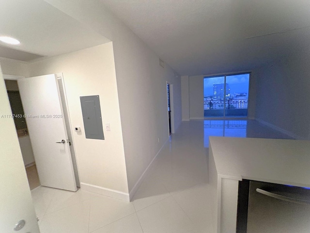 hallway with electric panel and tile patterned flooring