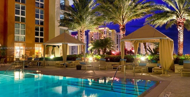 view of swimming pool featuring a patio area and a gazebo