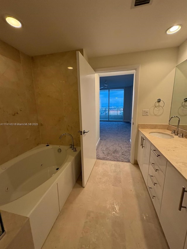 bathroom with vanity and a bath