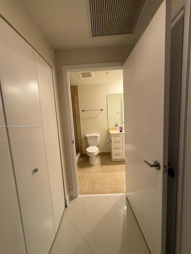 bathroom with vanity, toilet, and tile patterned floors