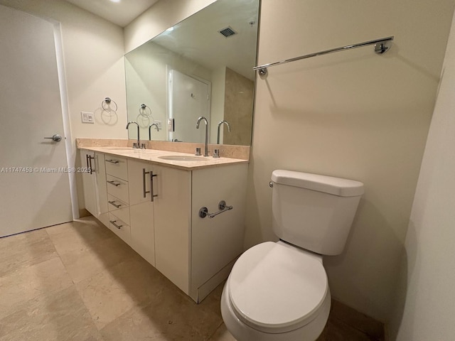 bathroom featuring toilet and vanity