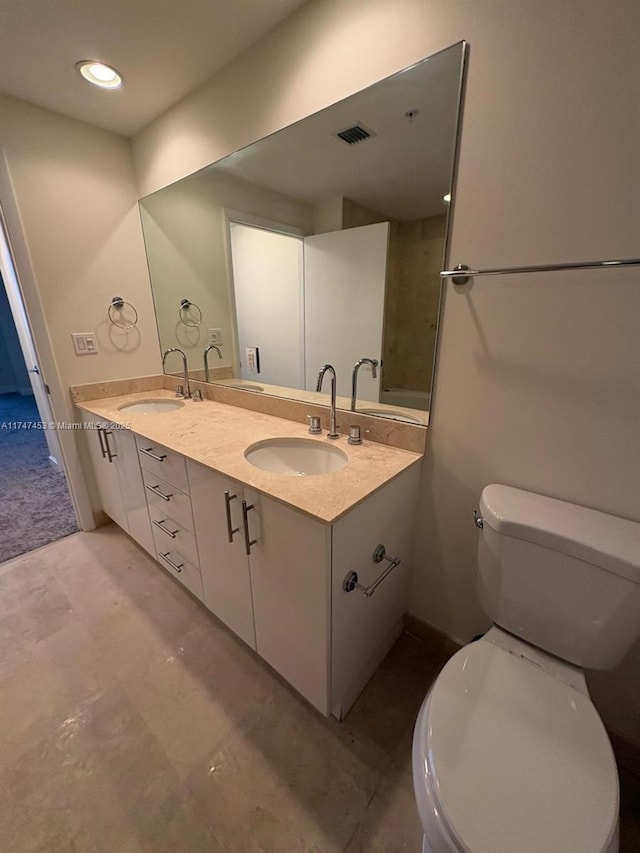 bathroom featuring toilet and vanity