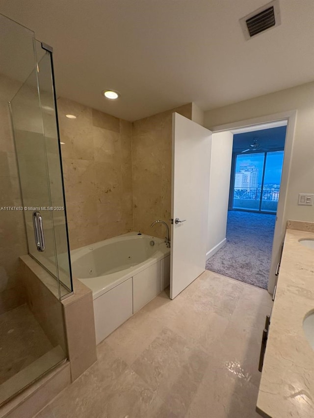 bathroom with separate shower and tub and vanity