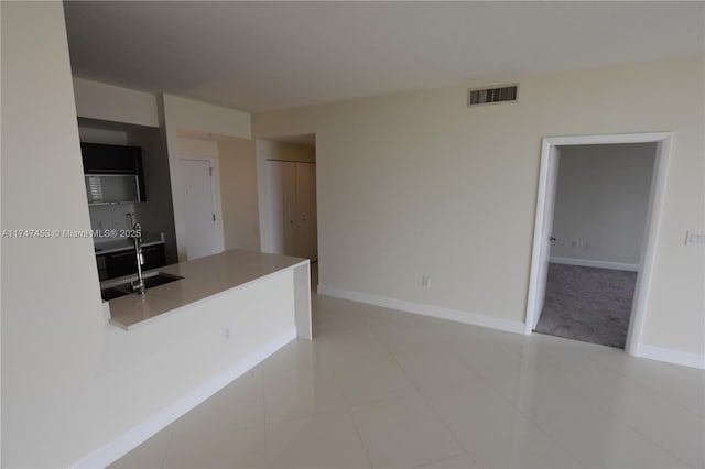 kitchen with light tile patterned floors and sink