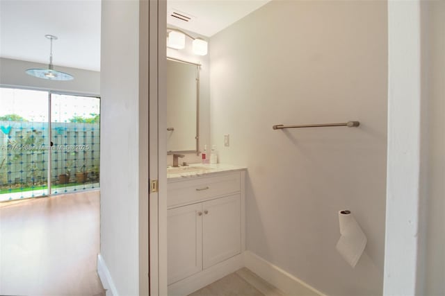 bathroom with visible vents, vanity, and baseboards