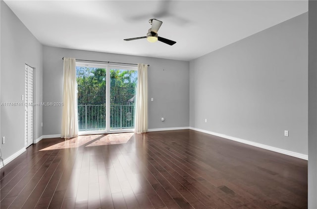 empty room featuring dark wood-type flooring and ceiling fan