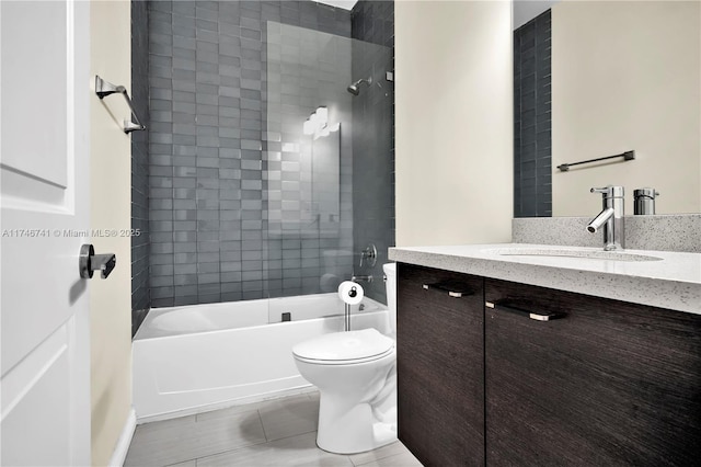 full bathroom featuring tiled shower / bath combo, vanity, and toilet