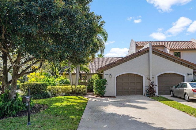 mediterranean / spanish house with a garage and a front lawn