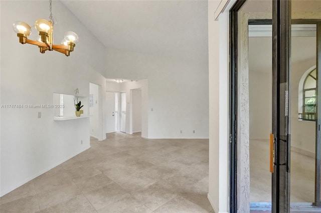 interior space featuring high vaulted ceiling and a notable chandelier