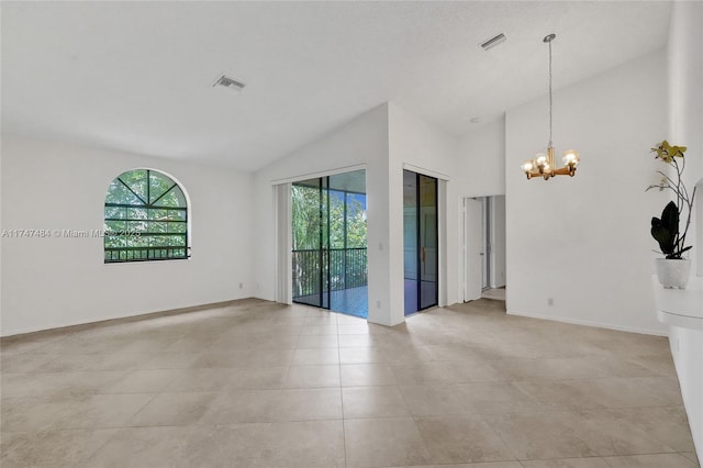 tiled spare room with plenty of natural light, a chandelier, and high vaulted ceiling