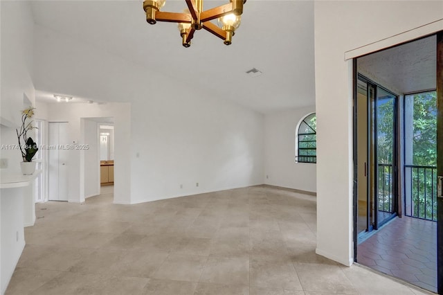 spare room with high vaulted ceiling and a chandelier