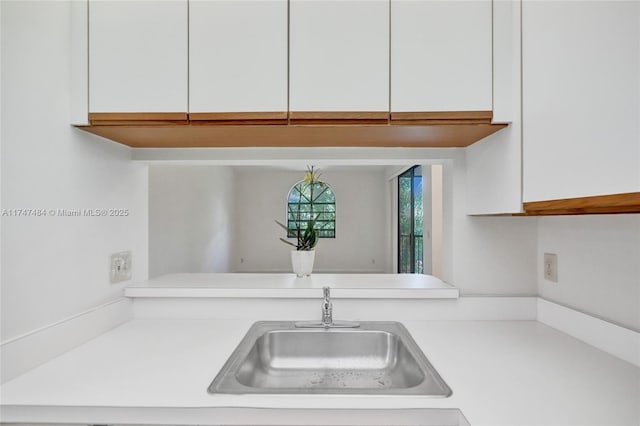 kitchen featuring sink and white cabinets