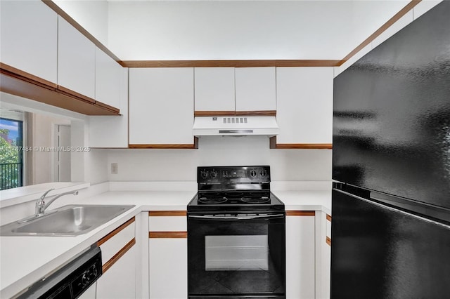 kitchen featuring sink, black appliances, and white cabinetry