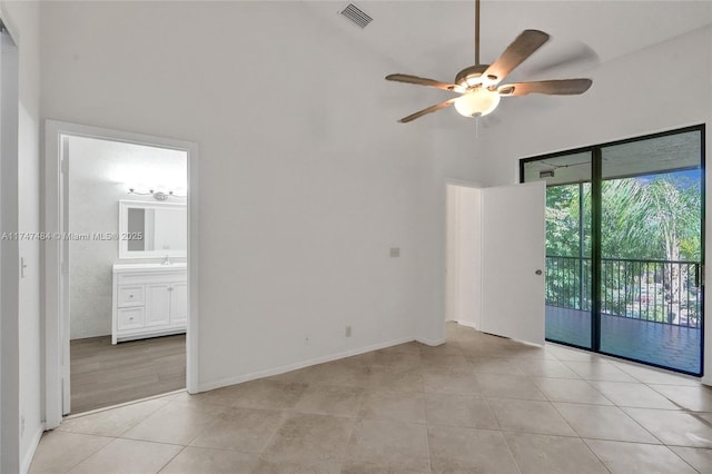 tiled spare room with ceiling fan