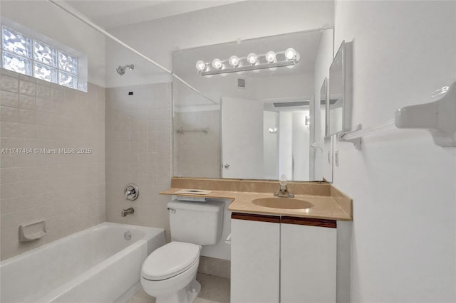 full bathroom featuring tiled shower / bath combo, vanity, and toilet