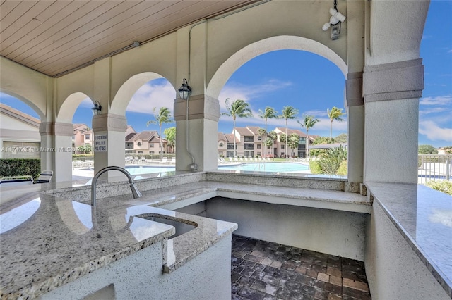 exterior details featuring sink and a pool