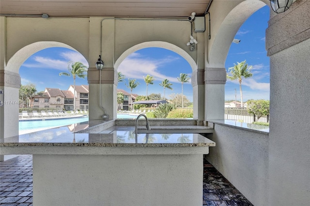 view of patio featuring a community pool and sink