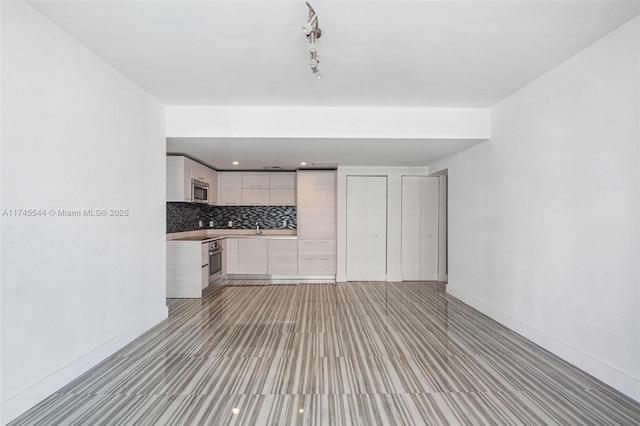 unfurnished living room with sink