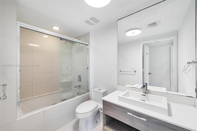 full bathroom featuring toilet, vanity, and combined bath / shower with glass door