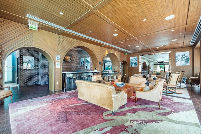 living room featuring dark hardwood / wood-style floors, indoor bar, and wooden ceiling