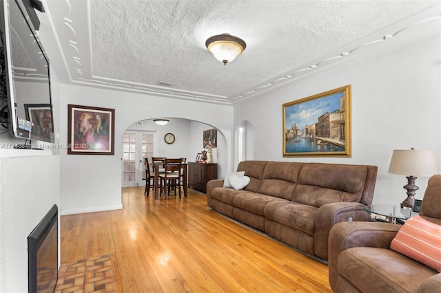 living room with a textured ceiling and wood-type flooring