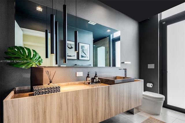 bathroom featuring tile patterned flooring, vanity, and toilet