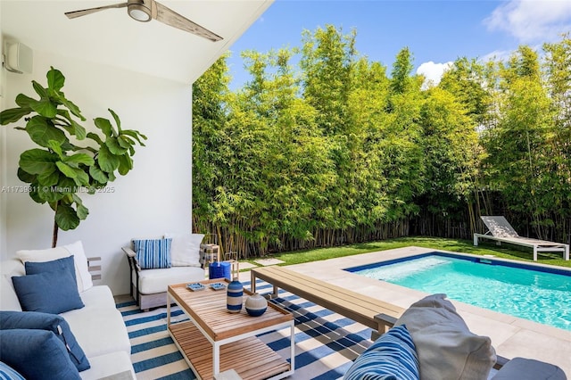 view of swimming pool with an outdoor living space, ceiling fan, and a patio area