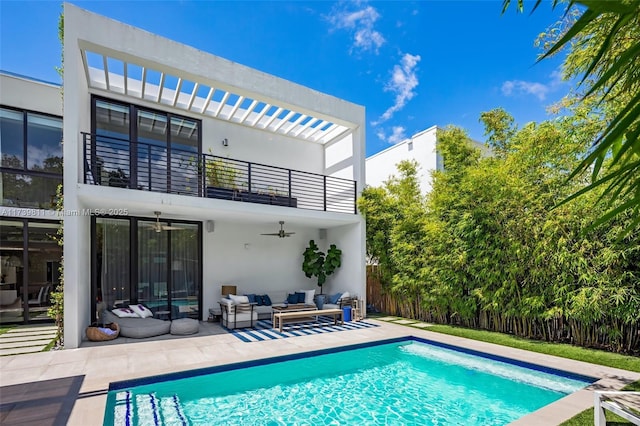 back of property featuring outdoor lounge area, a patio, a balcony, and ceiling fan