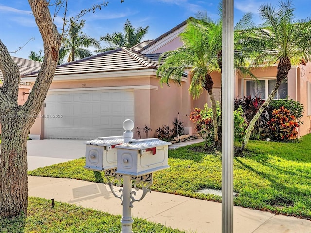 single story home featuring a front lawn and a garage