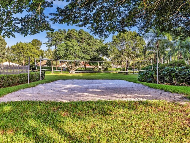 view of home's community with a yard and volleyball court