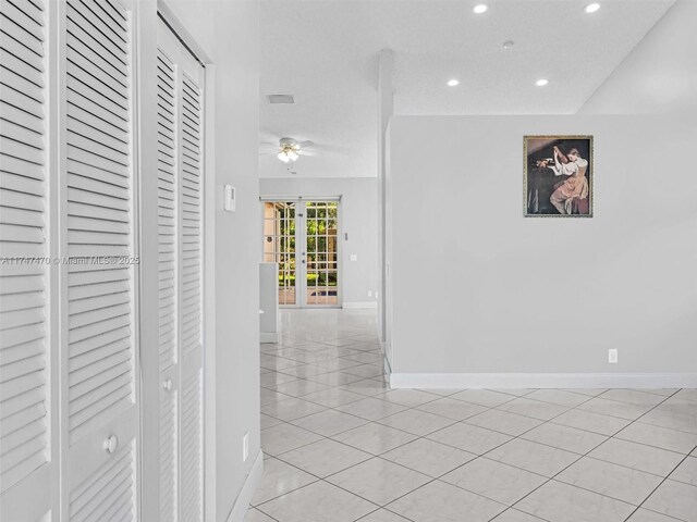 hall with light tile patterned floors