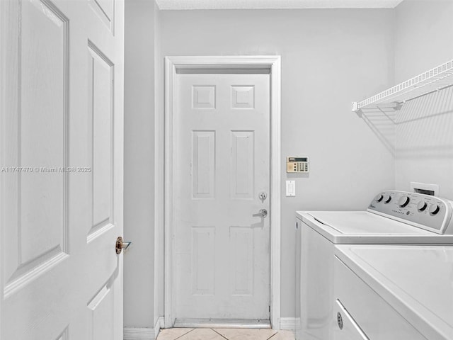 laundry room featuring independent washer and dryer and light tile patterned floors