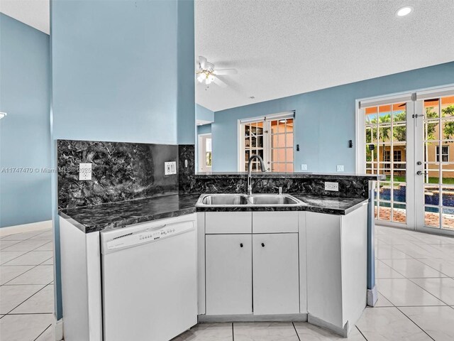 kitchen featuring white cabinets, kitchen peninsula, dishwasher, and sink