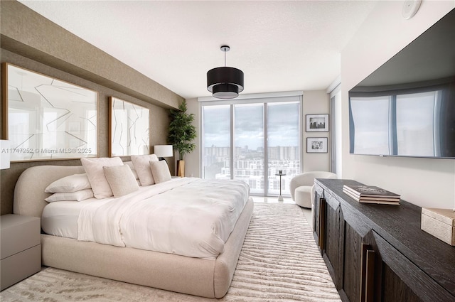 bedroom featuring access to outside and a textured ceiling