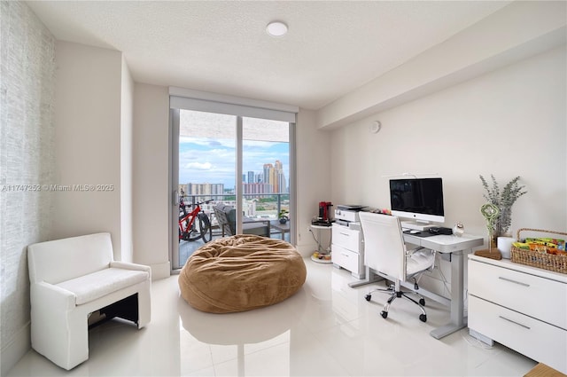 tiled office space with a textured ceiling and expansive windows