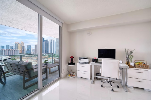 tiled office featuring expansive windows and a textured ceiling