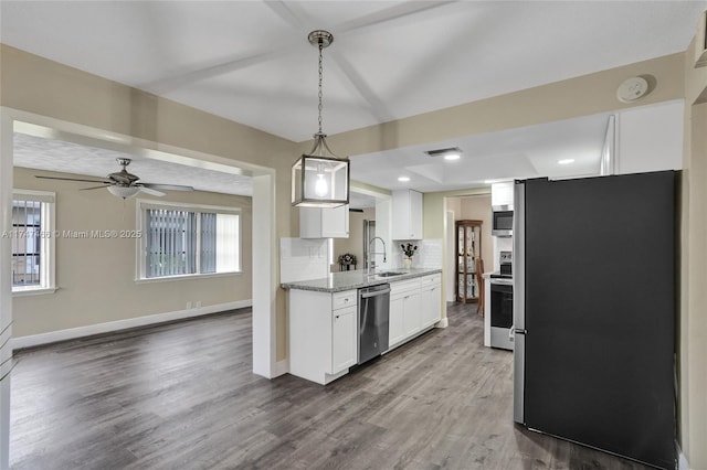 kitchen with white cabinetry, sink, appliances with stainless steel finishes, decorative backsplash, and pendant lighting