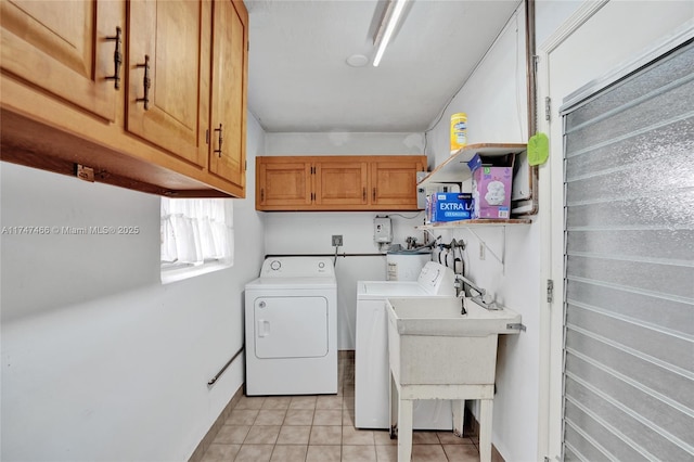 laundry room featuring washer and dryer, cabinets, sink, and light tile patterned floors