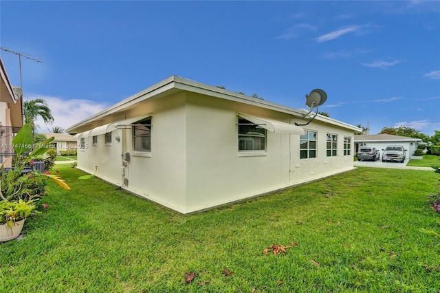 view of side of property with a lawn