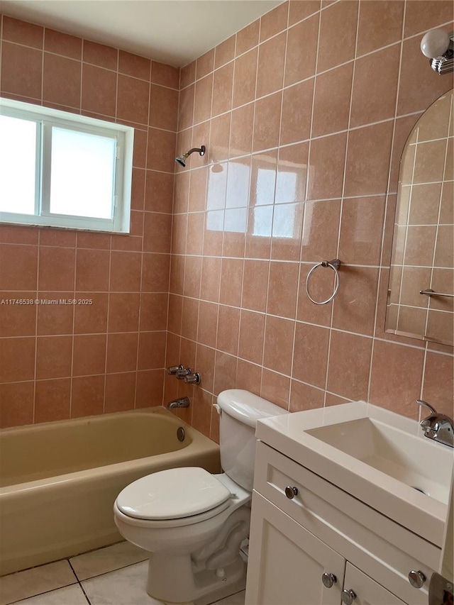 full bathroom with vanity, tile patterned flooring, toilet, and tiled shower / bath